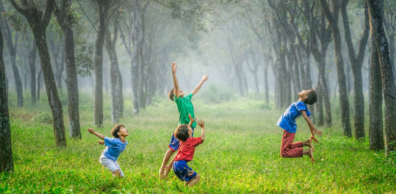kids jumping in forest